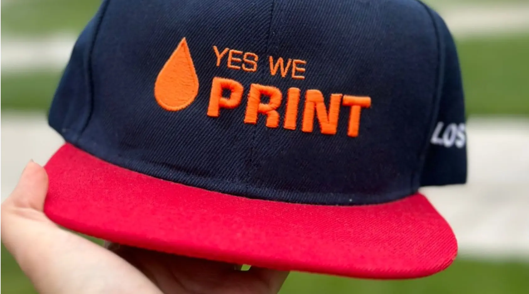 A hat with yes we print logo on it.