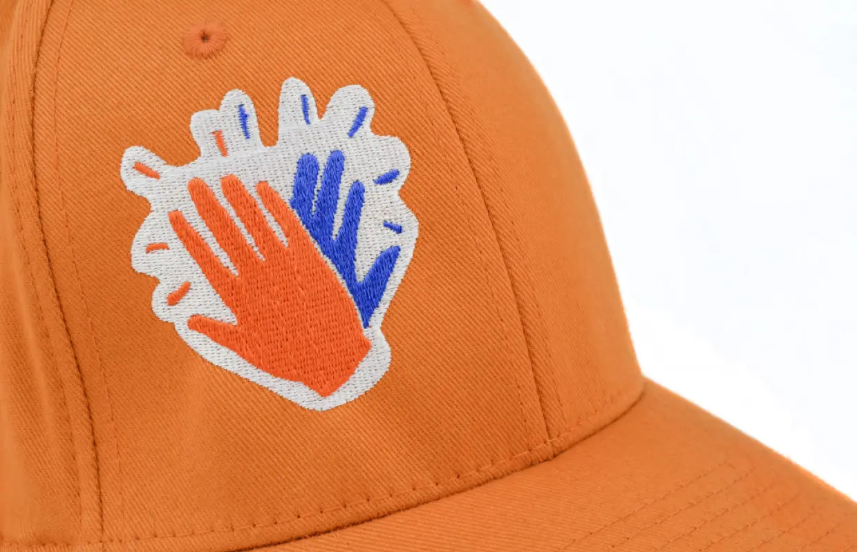 Orange cap with hands print on it